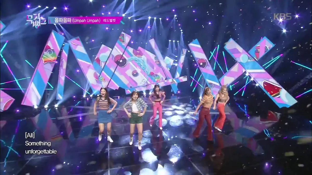 Red Velvet members dancing amidst glamorous stage backgrounds