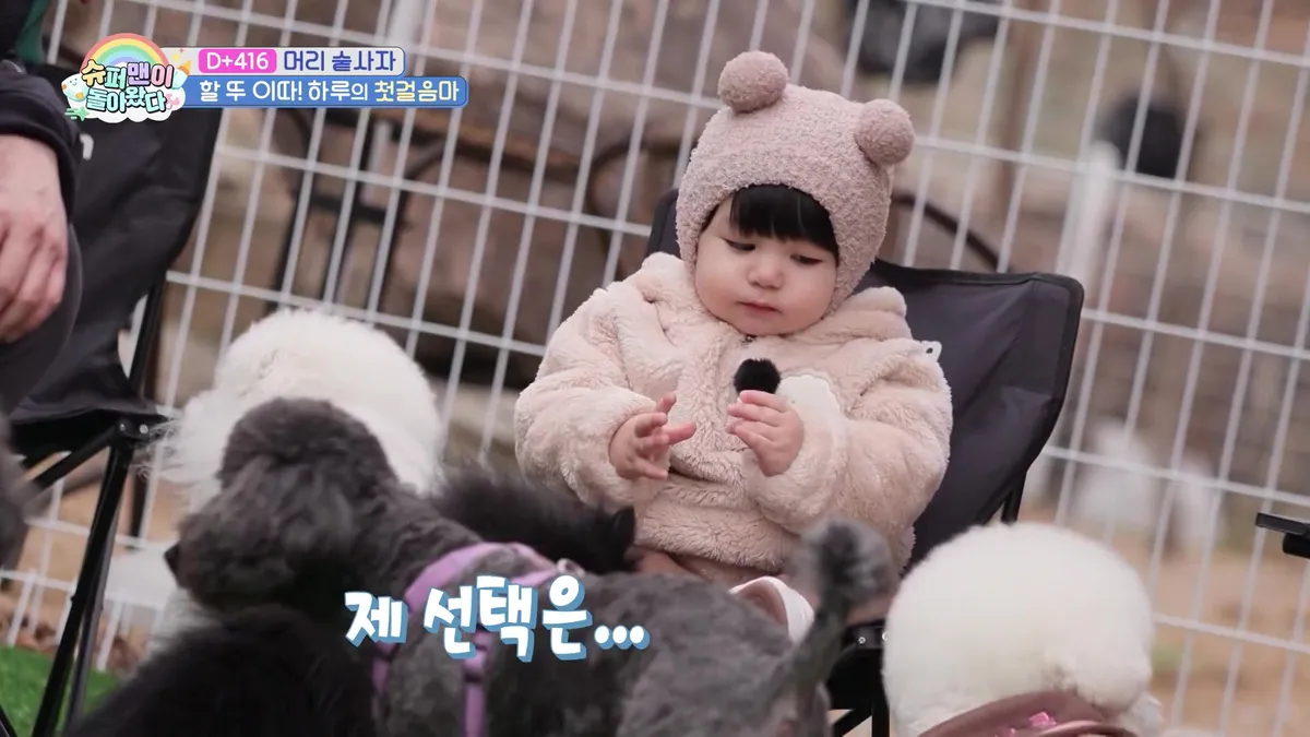 Haru, Wearing a Teddy Bear Hat, Sits in a Chair Lost in Thought