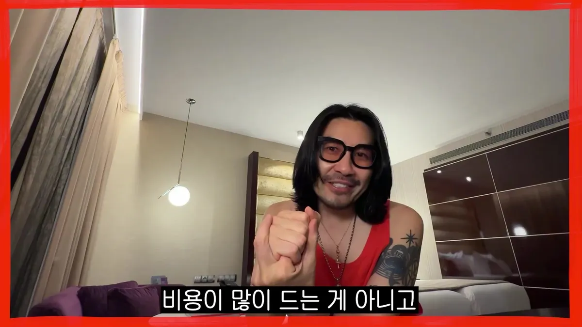 Noh Hong-chul smiling while wearing glasses and clenching his fist