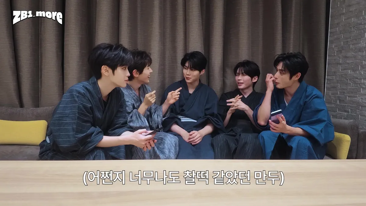 ZEROBASEONE members sitting on a sofa and having a conversation