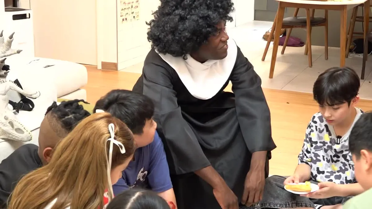 Jonathan dresses up as the choir director from the movie Sister Act to talk with children