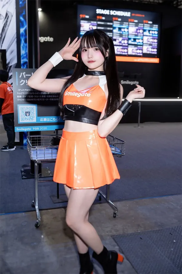 Model Mizuumiramune showcases slim silhouette with refreshing salute pose at Smilegate booth during TGS 2026