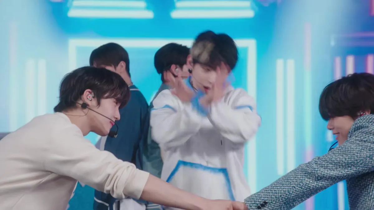 D.N.X performs group choreography on a neon stage in official MV