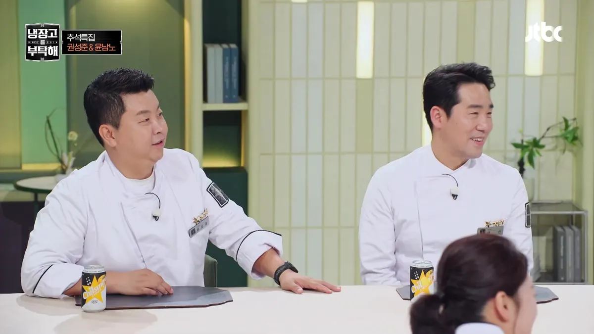 Chefs Kwon Seong-jun and Yoon Nam-no sharing a conversation at a table