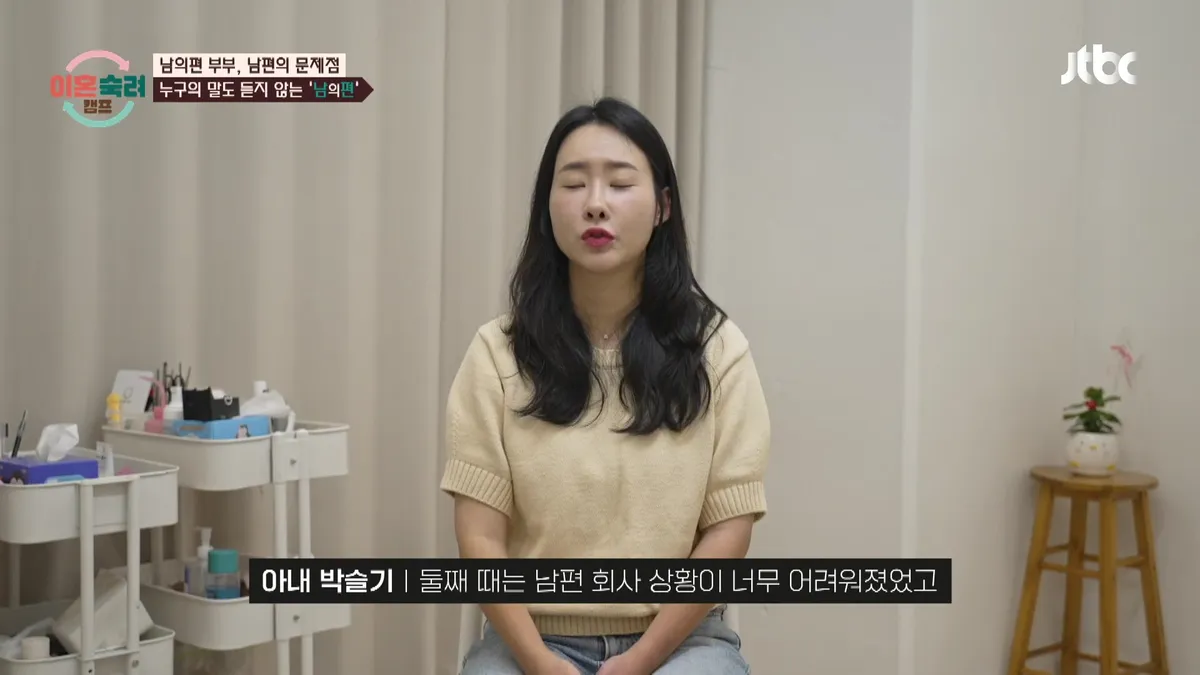 A husband and wife sitting across from each other at a dining table, sharing a conversation