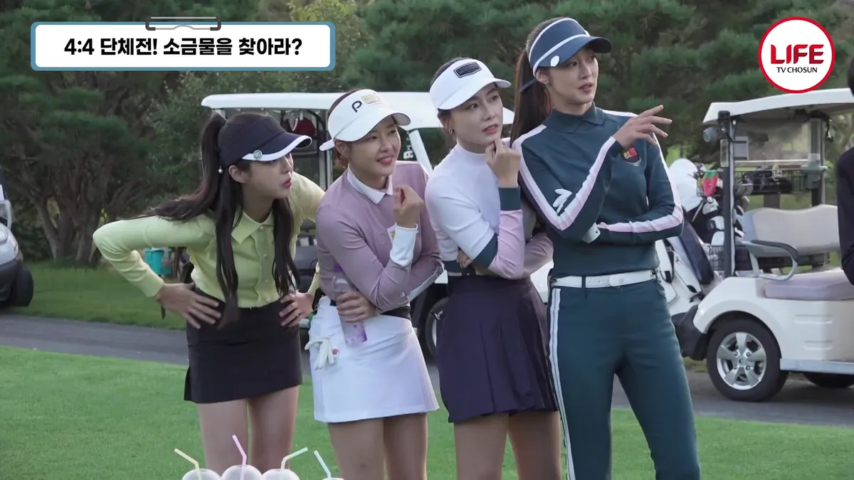 Four women in golf wear pose outdoors