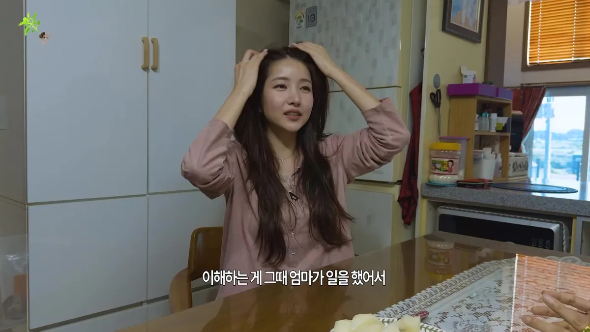 Kim So-won engages in conversation while touching her hair