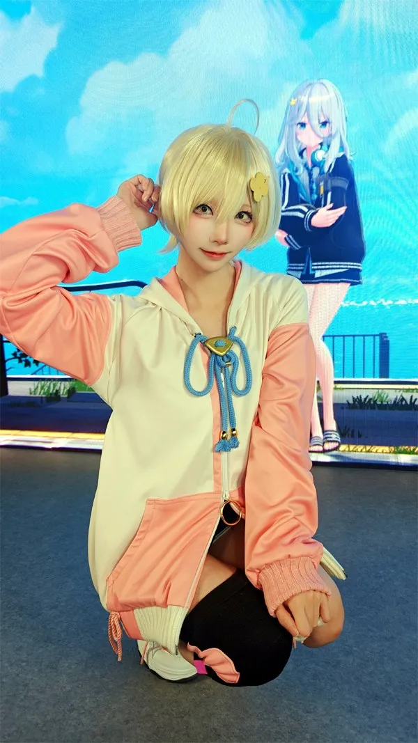 Model Kitaro Radiates Fresh Cuteness in Pink Training Hoodie in Front of Pearl in Blue Booth's Large LED Screen