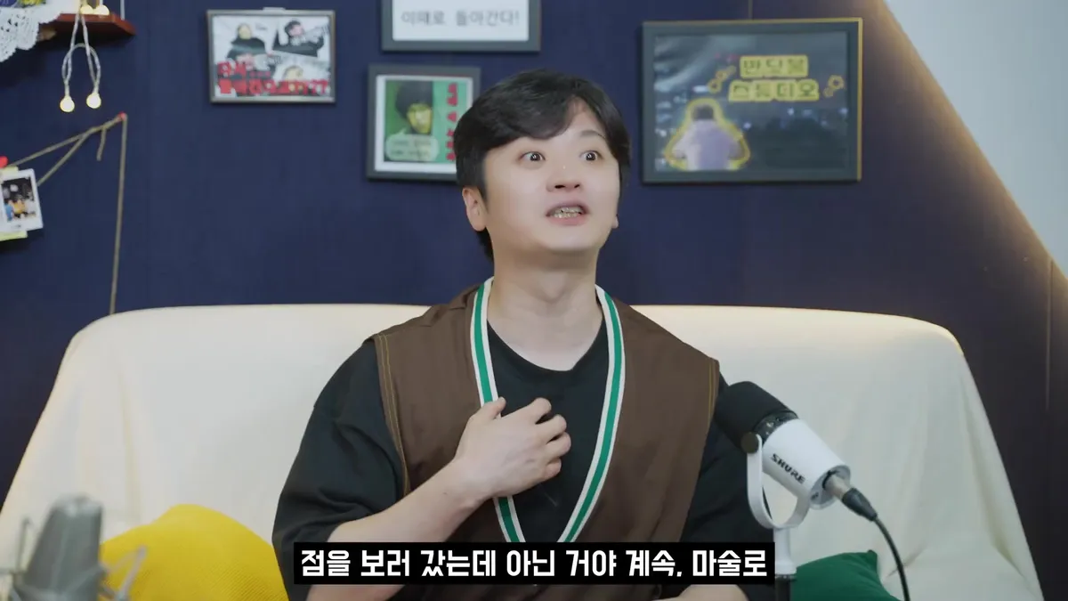 Magician Kim Jun-pyo sits on a sofa, sharing stories